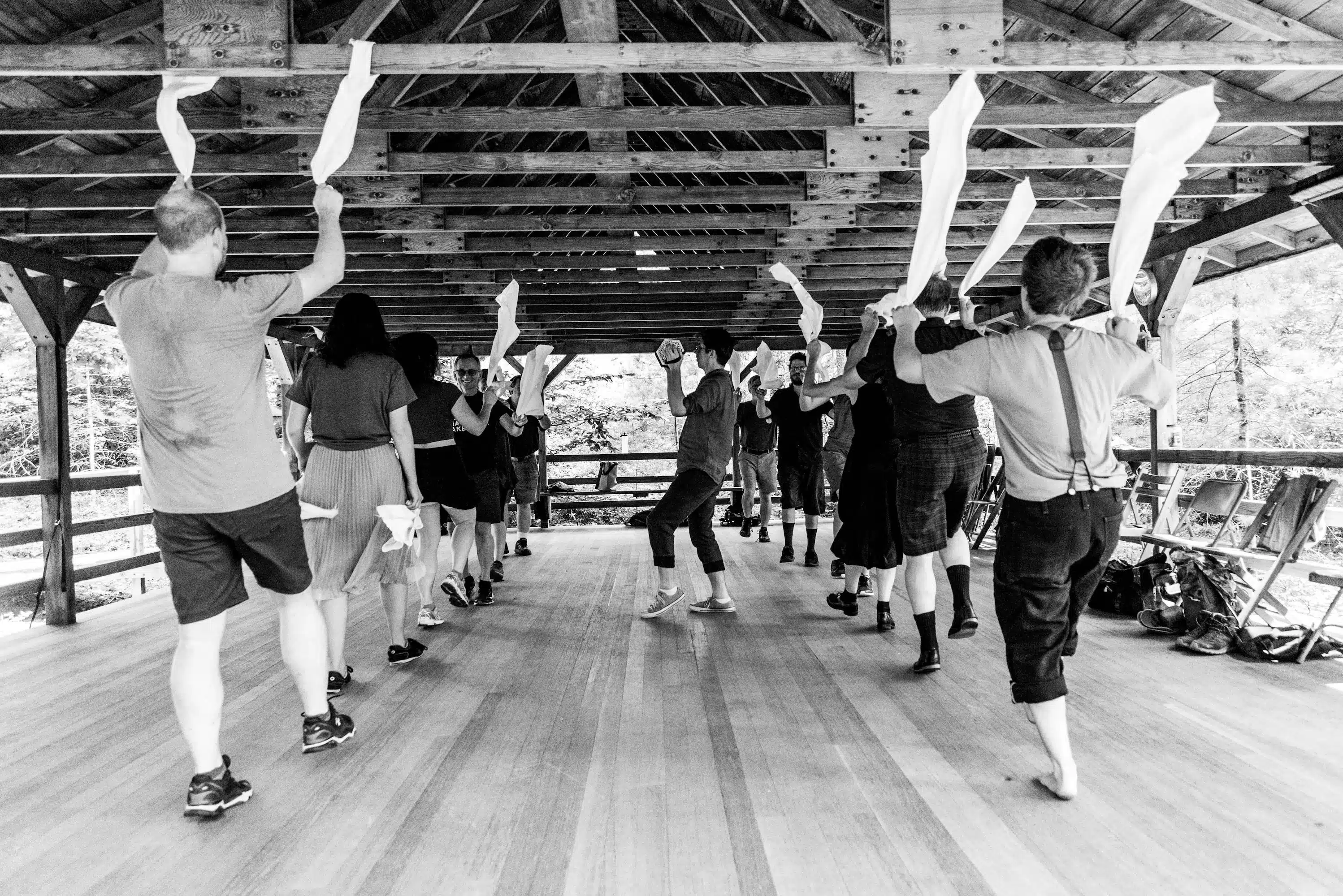 Dancers twirling white handkerchiefs in the air