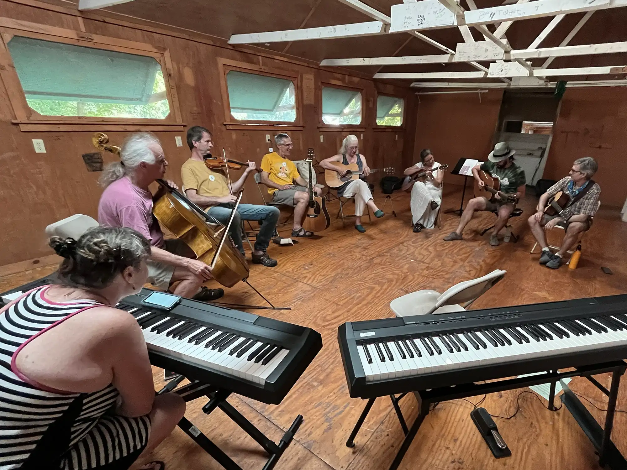 Musicians playing in a circle. Photo by Elvie Miller.